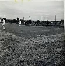 Players on the original grass court in the early days of the club